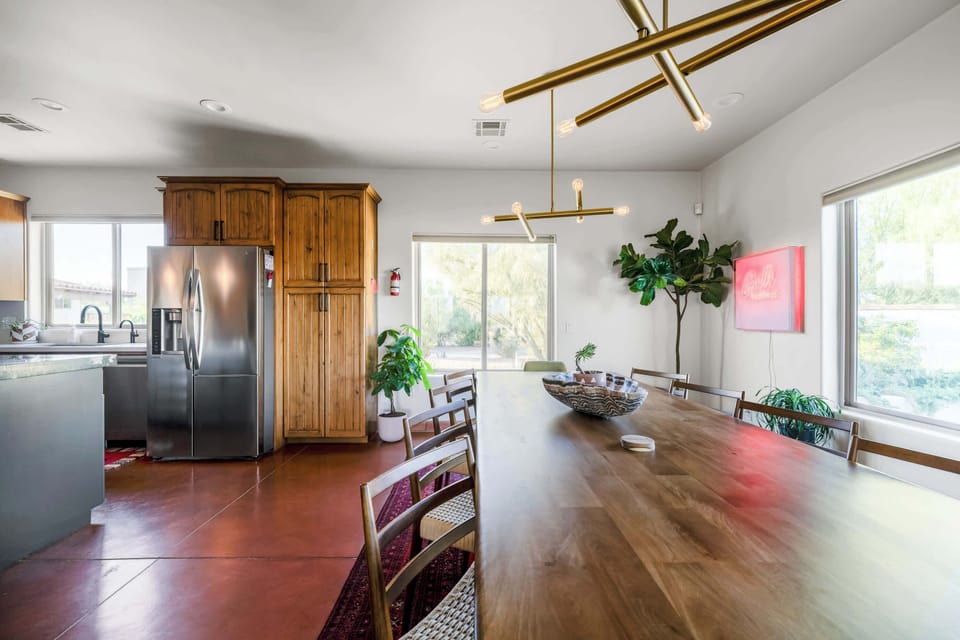 Sunny dining area with a big farmhouse table.