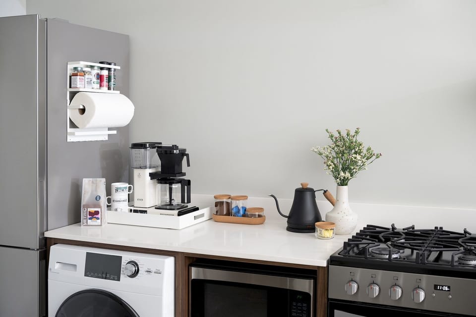 Moccamaster, Metric coffee grounds, electric kettle, spices, creamer, sugar, olive oil. 