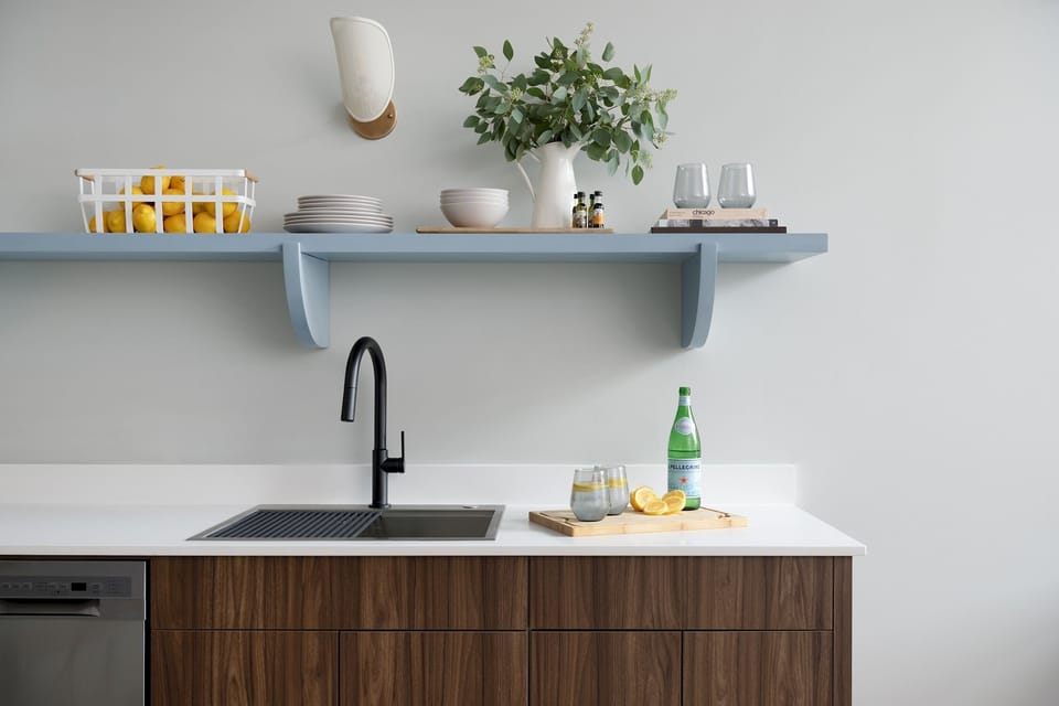 Sink, plates, bowls, dishwasher, wine glasses. 