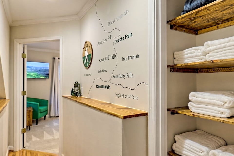 "Discover the best local hiking spots with our custom trail map, featuring popular destinations like Desoto Falls, Anna Ruby Falls, and Yonah Mountain. Conveniently located in the hallway, it's your guide to exploring nature during your stay."