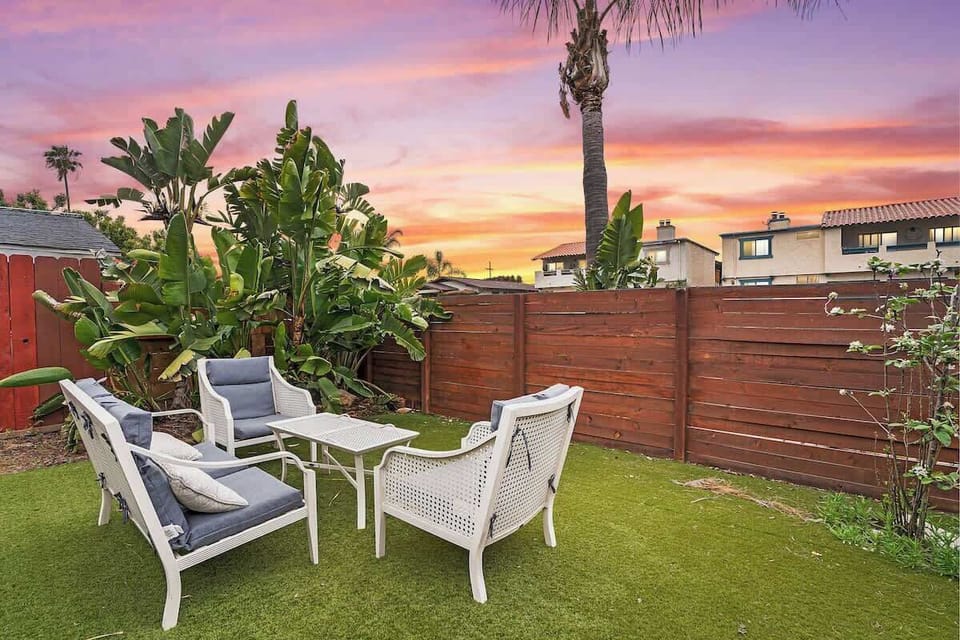 Sunset backyard lounge with turf and seating, perfect for golden hour at our North Park home