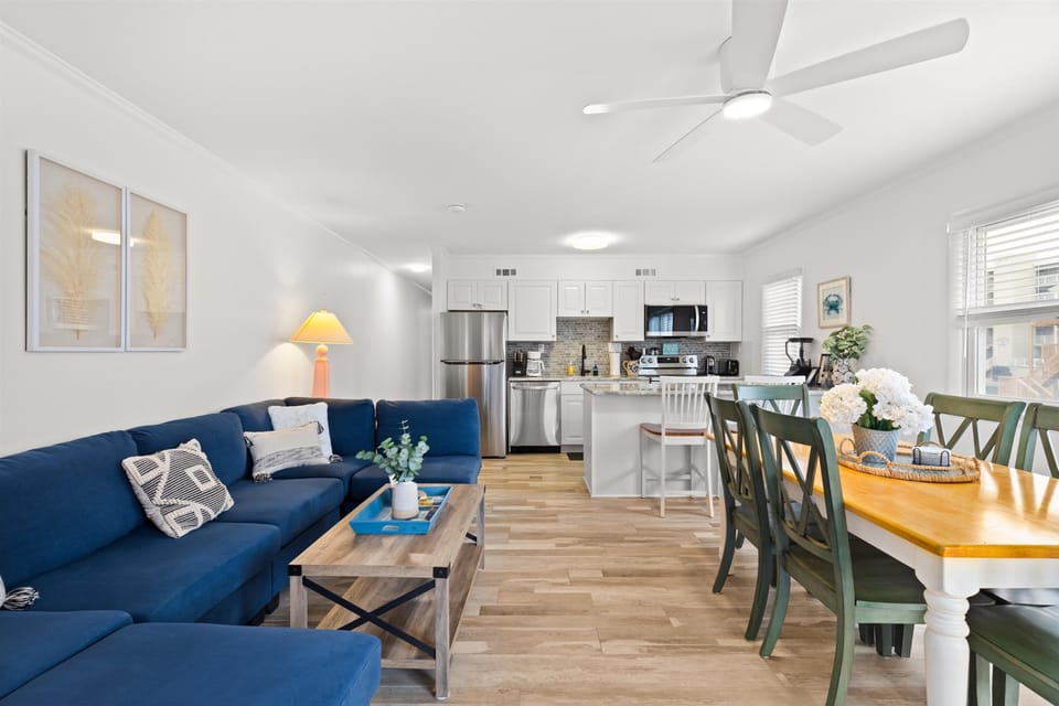 Open concept living area with comfortable seating, a Smart TV, dining table for 6, breakfast bar, and newly renovated kitchen