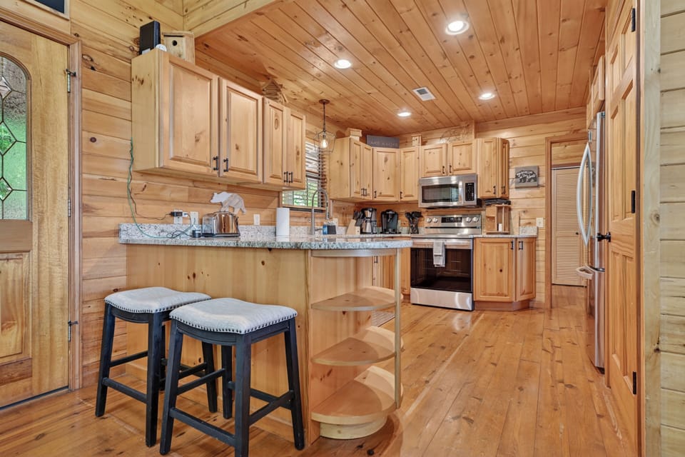The kitchen opens into the main living space, keeping everyone connected during your mountain vacation