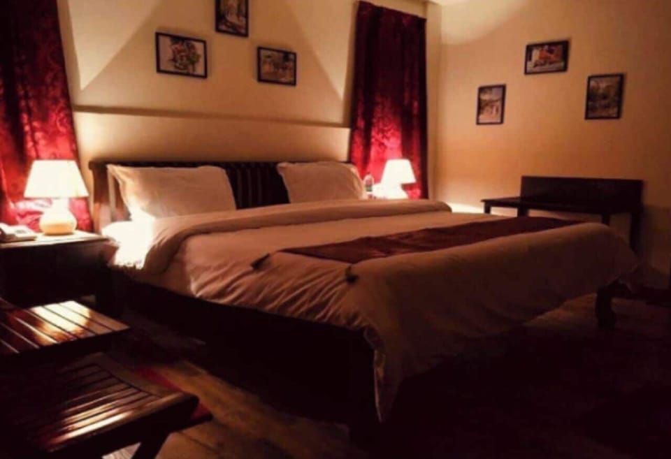 Desk, iron/ironing board, bed sheets