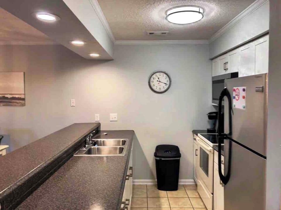 Where Culinary Wonders Unfold: A Sleek and Well-Equipped Kitchen
