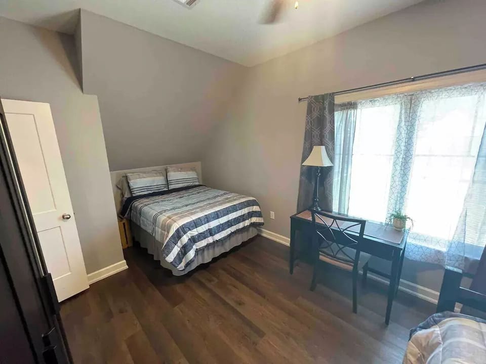 Picture of the full bed and the desk.