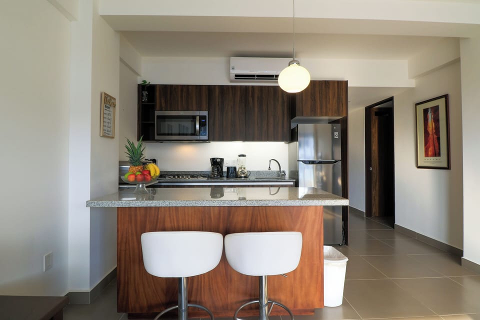 Our kitchen island made of parota wood and granite countertop, and 2 stools