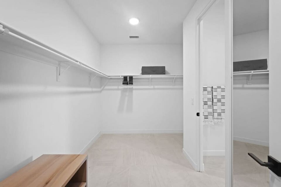 Spacious walk-in closet w/ built-in shelving & plenty of hanging space
