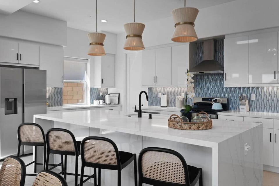 Sleek kitchen island w/ bar seating, stainless appliances & stylish finishes