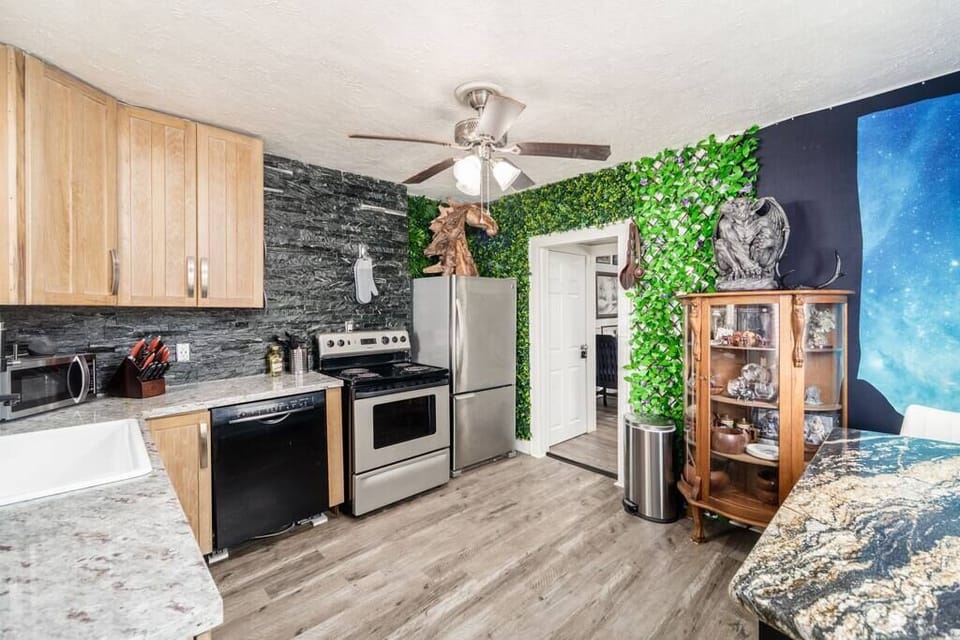 Your open kitchen includes a granite island, display cabinet and refrigerator horse.