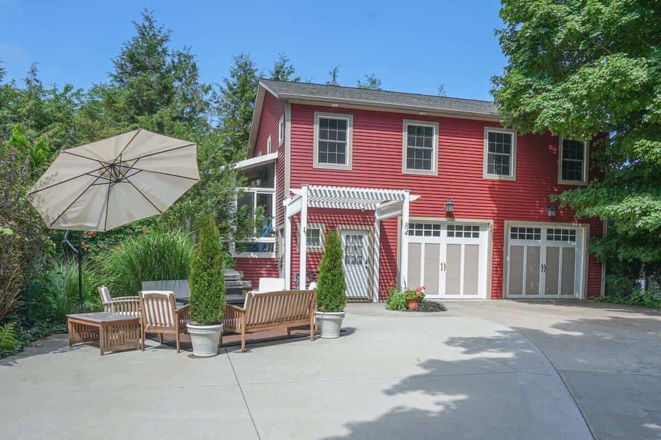 Outside of house with comfortable seating and gas grill 