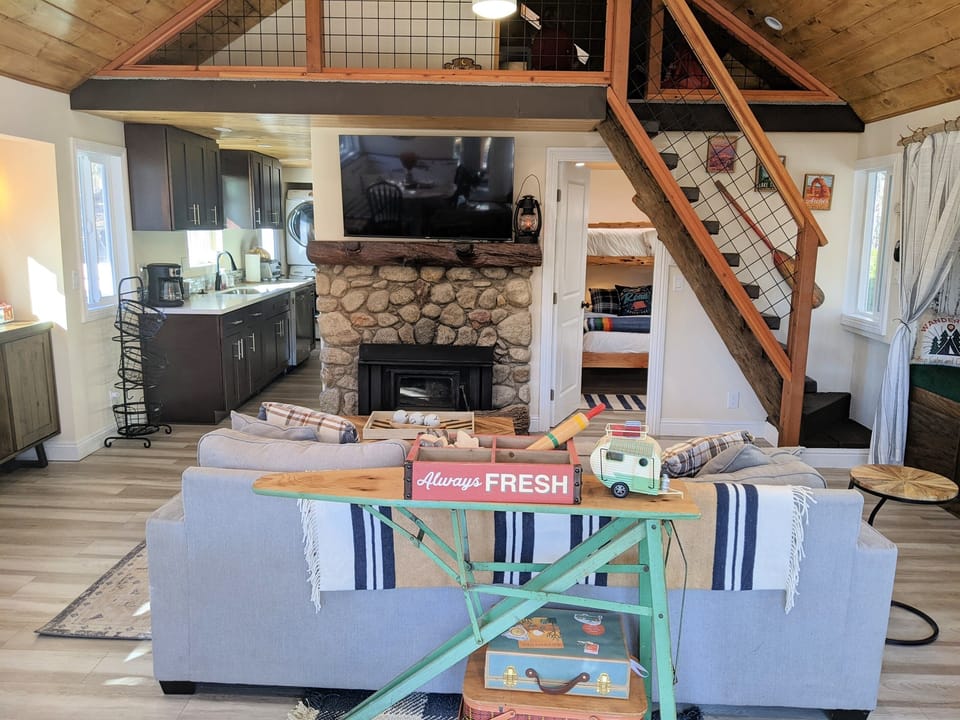 The main living space has a sectional, dining area, reading nook and rocking chair.  There is also wood burning fireplace and TV with both cable and smart app capabilities.  
