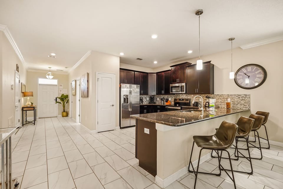 Spacious modern kitchen with sleek appliances and a large island, perfect for entertaining and culinary adventures.