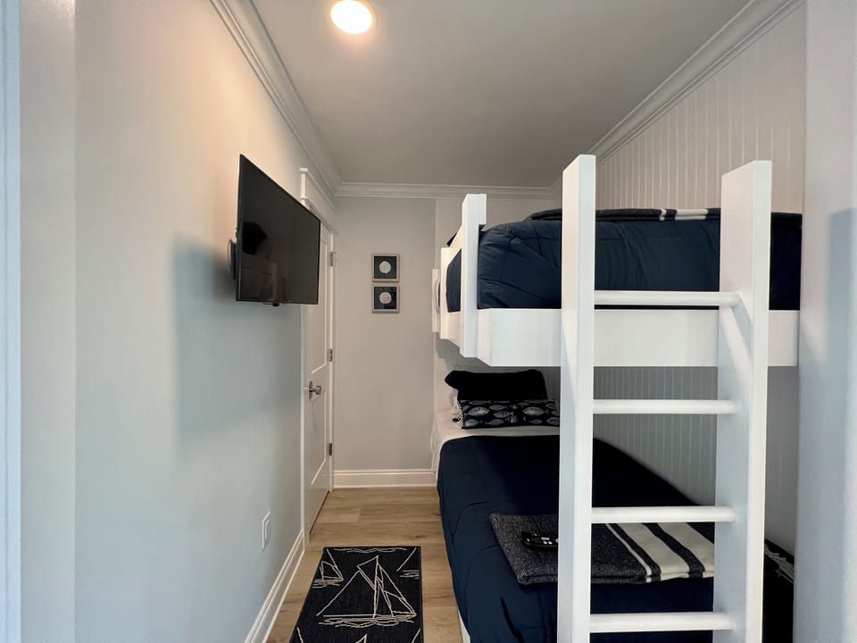 Cozy bunk room where your group can rest comfortably after adventure-filled days, complete with your own entertainment setup.