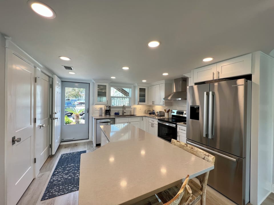 Your modern kitchen awaits with gleaming countertops, stainless steel appliances, and bright natural light streaming through crisp white cabinets.