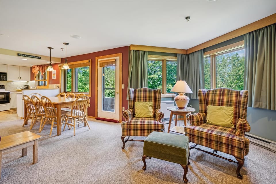 Two oversized armchairs beside large windows create the perfect spot for morning coffee or evening reading.