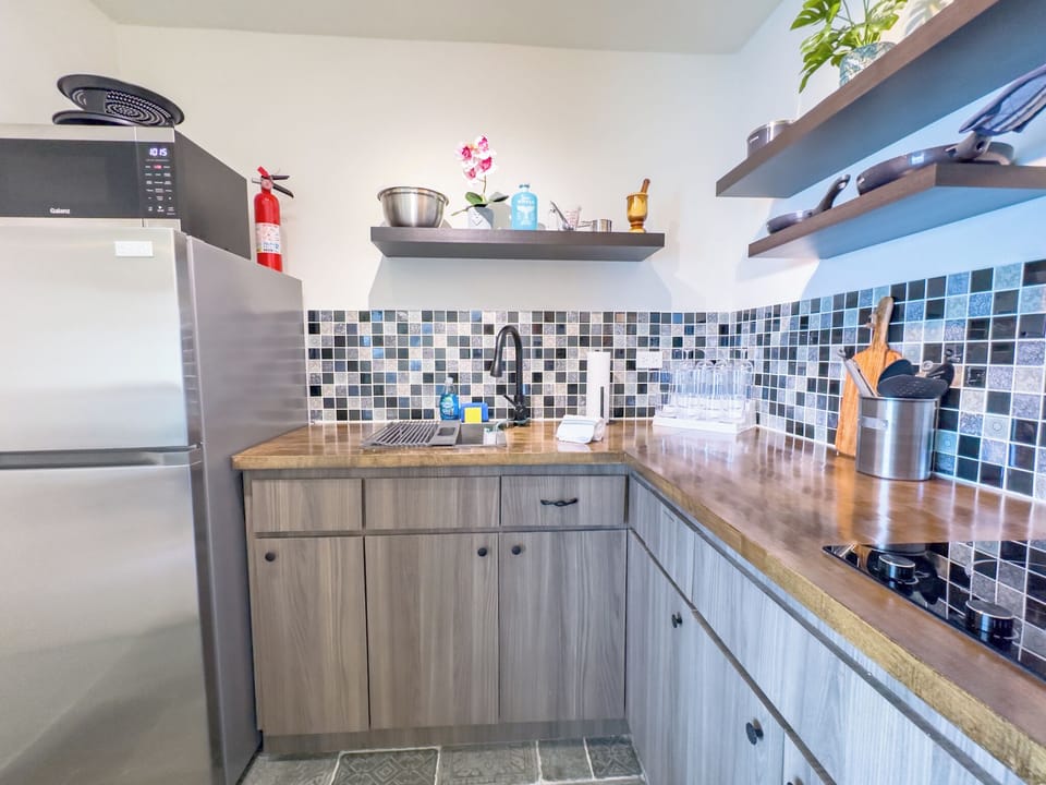 Modern Kitchen: Craft delicious meals in a stylish space with vibrant tile accents!