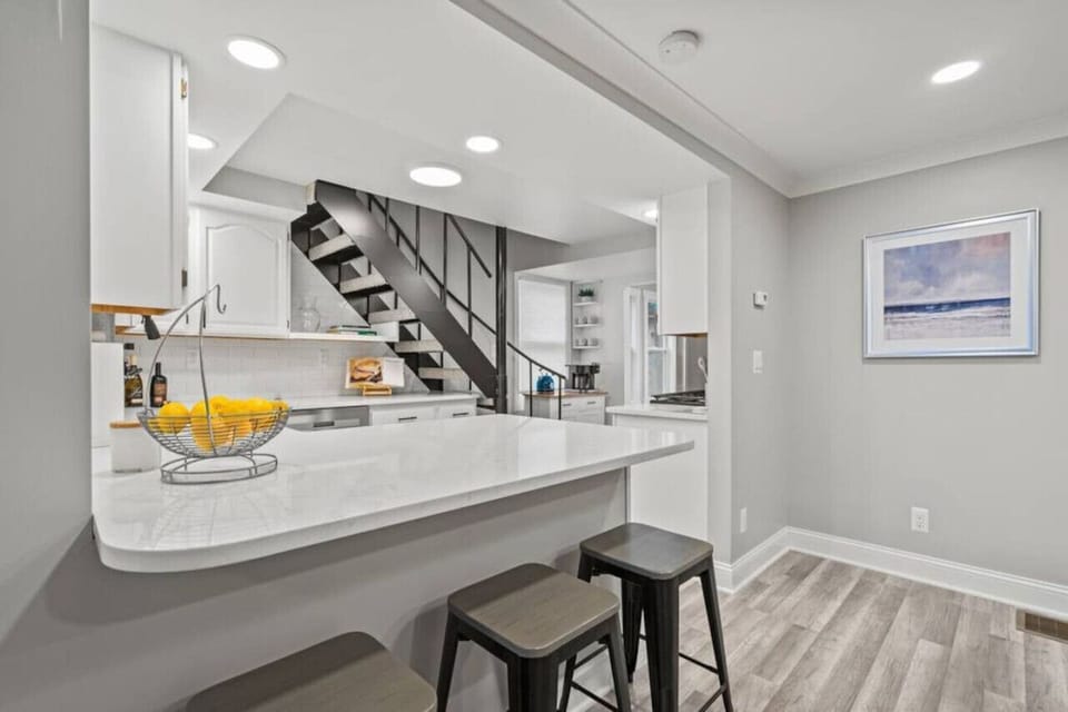 Kitchen is equipped with barstool seating