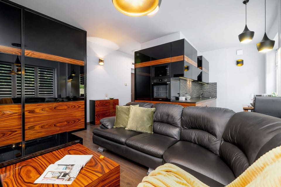 Modern interior with black leather sofa and stylish custom-made furniture.