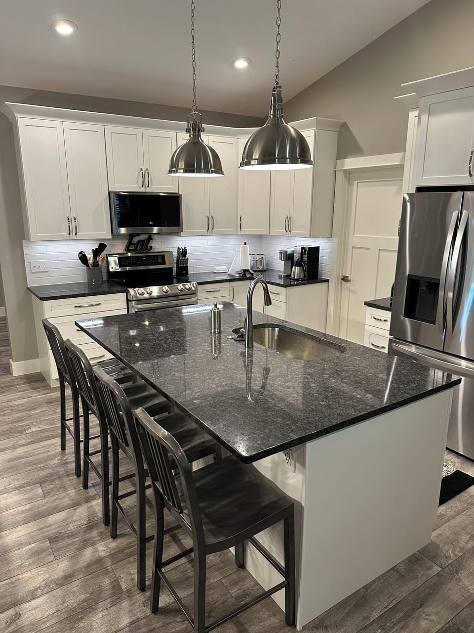 Kitchen with granite countertops, plenty of room for cooking and bar seating