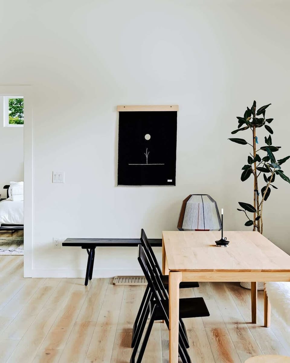 Minimalist styling meets cozy vibes in this serene dining area.