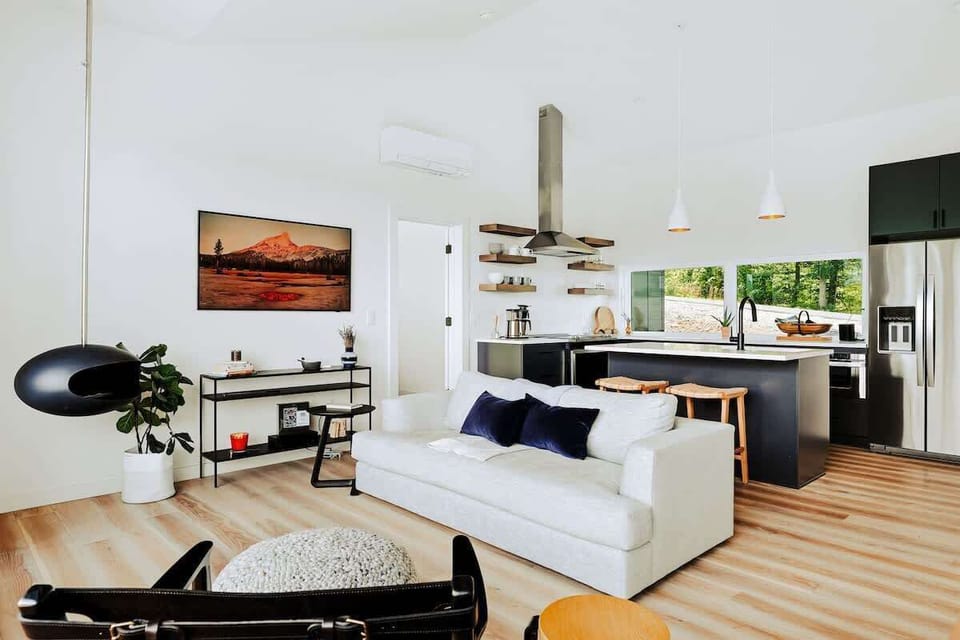 A modern open-concept layout where sleek design meets cozy comfort—perfect for entertaining or just kicking back with a view.