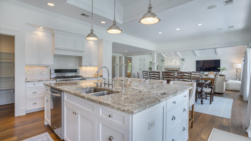 This gourmet kitchen combines elegance and function with its expansive granite island, double sinks, and bar seating for effortless entertaining.