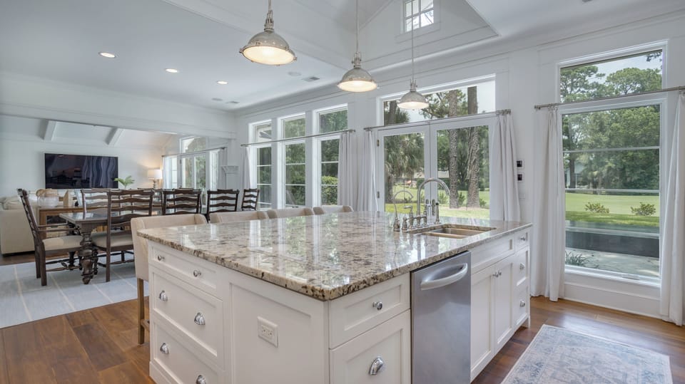 The open layout flows into the dining and living areas, offering a bright, connected space ideal for gatherings.