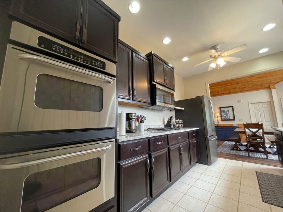 Main floor kitchen boasts a full modern style, granite counters with a double oven, drip coffee & Pod coffee machine. Fully stocked to accommodate the cooks in the family