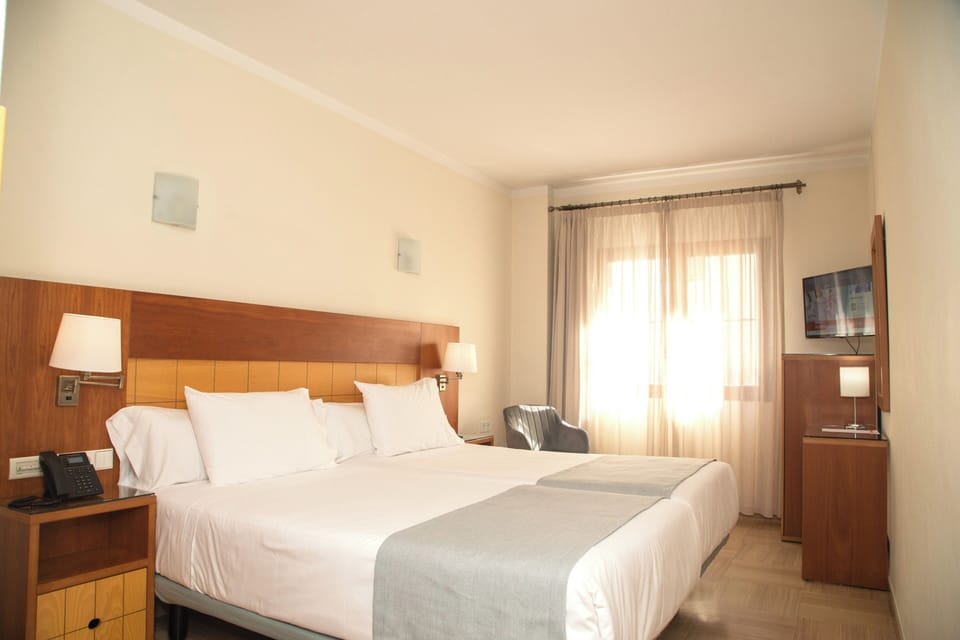 Standard Double Room | Minibar, in-room safe, desk, blackout drapes