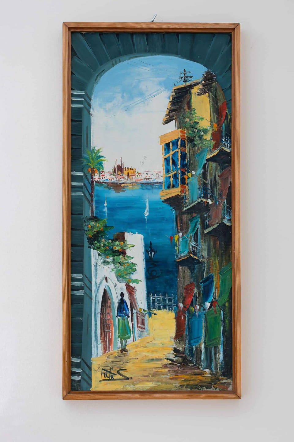 A picture in a wooden frame hanging on the wall.