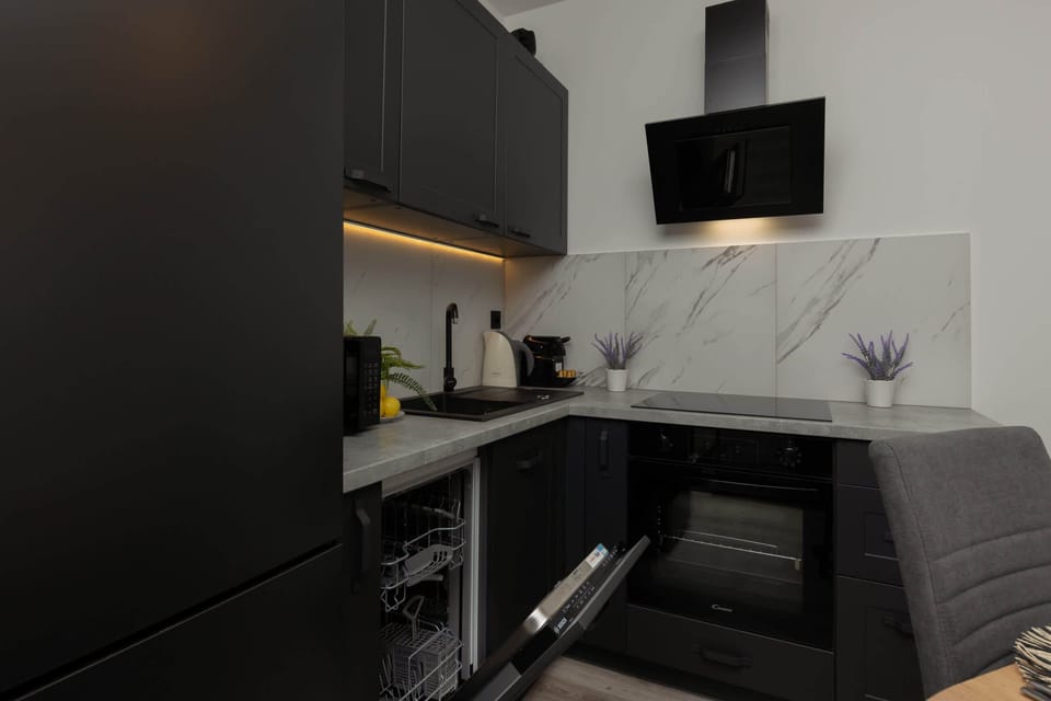 The sleek design of the kitchenette blending seamlessly with the living area.