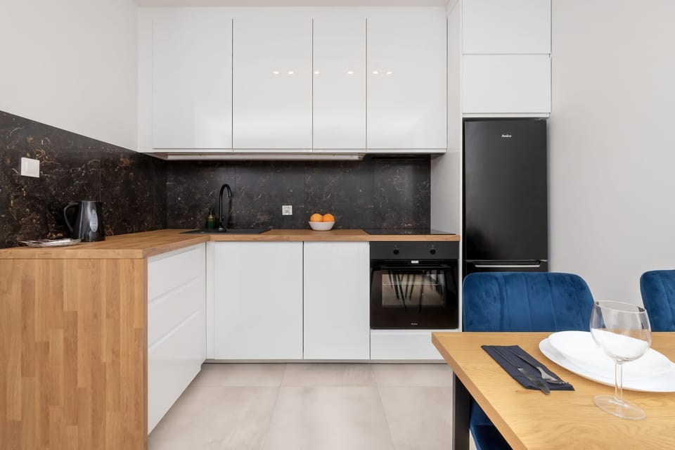 The sleek design of the kitchenette blending seamlessly with the living area.