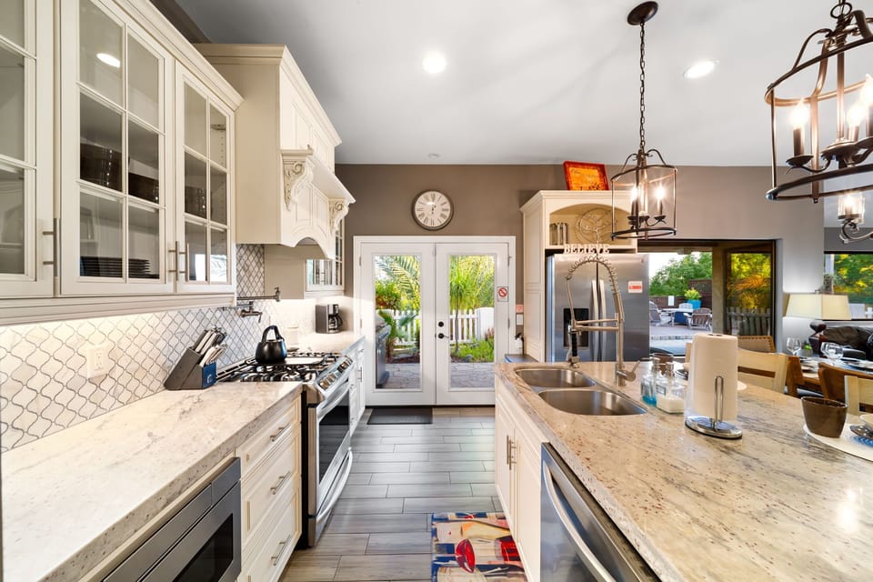 Kitchen is equipped with stainless steel appliances and cooking basics.