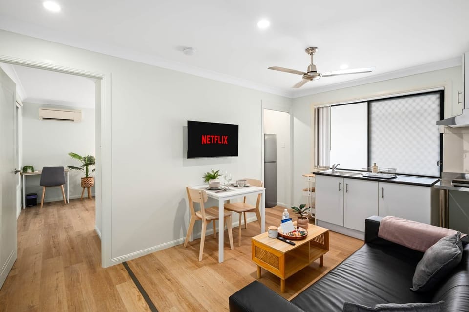 Living Area: Bright living space with comfortable seating and TV 