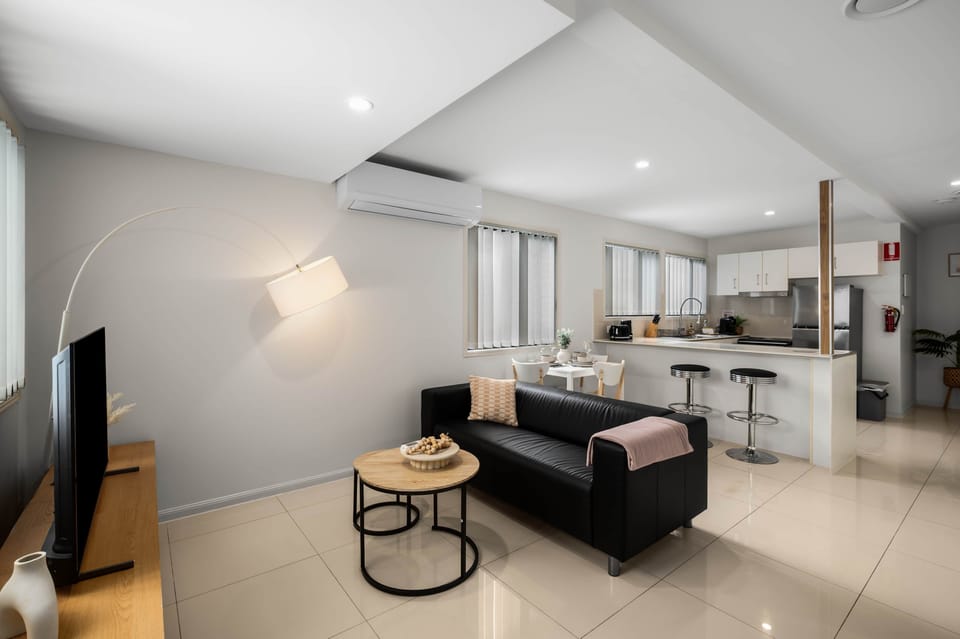 Living Area: Bright living space with comfortable seating and TV 
