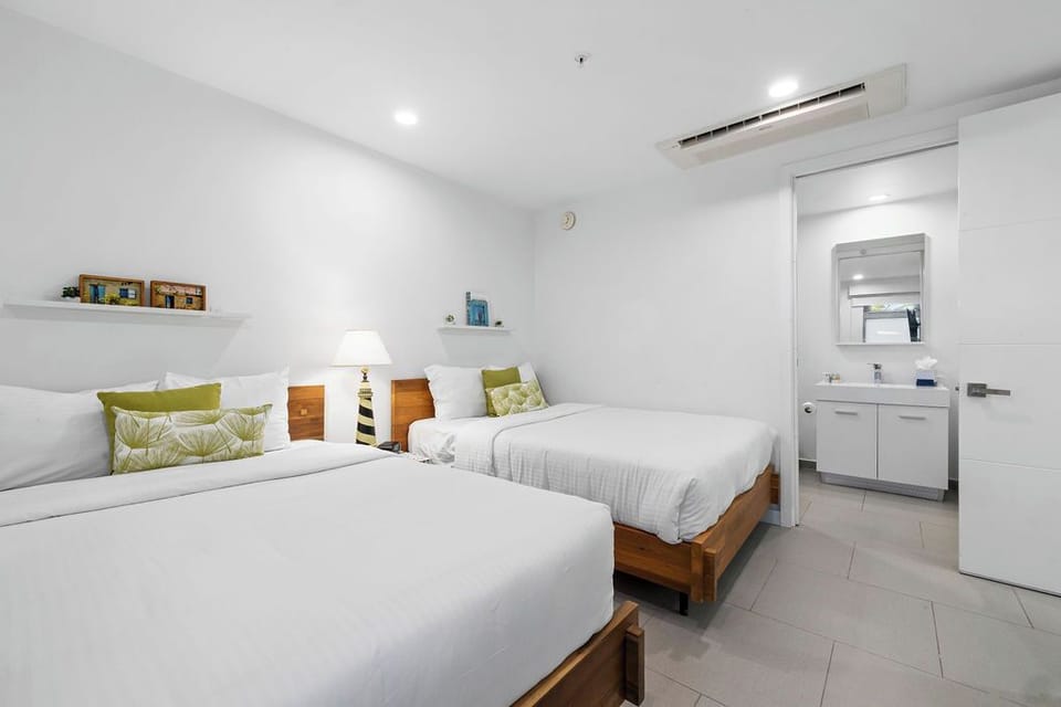 Sink into crisp linens and unwind in your bright, clean bedroom with two comfortable beds, climate control, and an ensuite bathroom just steps away.