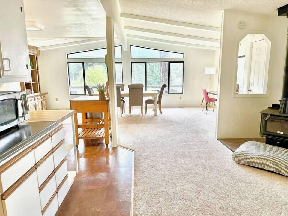 Bright dining area with vaulted ceilings and picture windows with Rosario views.
