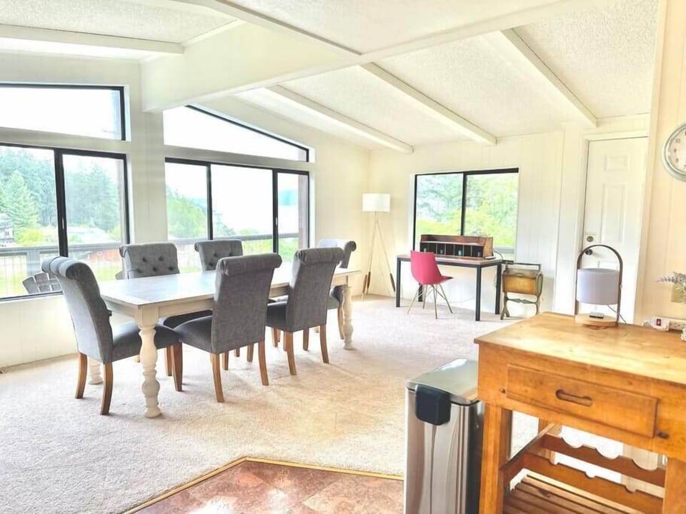 Spacious dining area with vaulted ceilings and expansive Rosario Strait views.