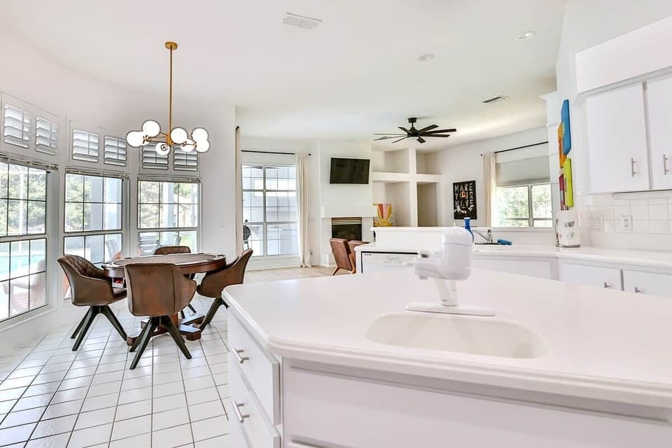 Spacious kitchen with large center island offers additional workspace and meal prep area with views of the dining area and living spaces.