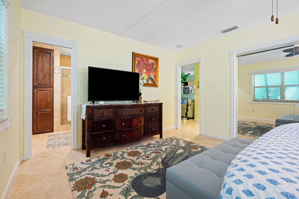 Master Suite: Tommy Bahama Dressers, 55 inch Smart TV, en-suite bathroom.
