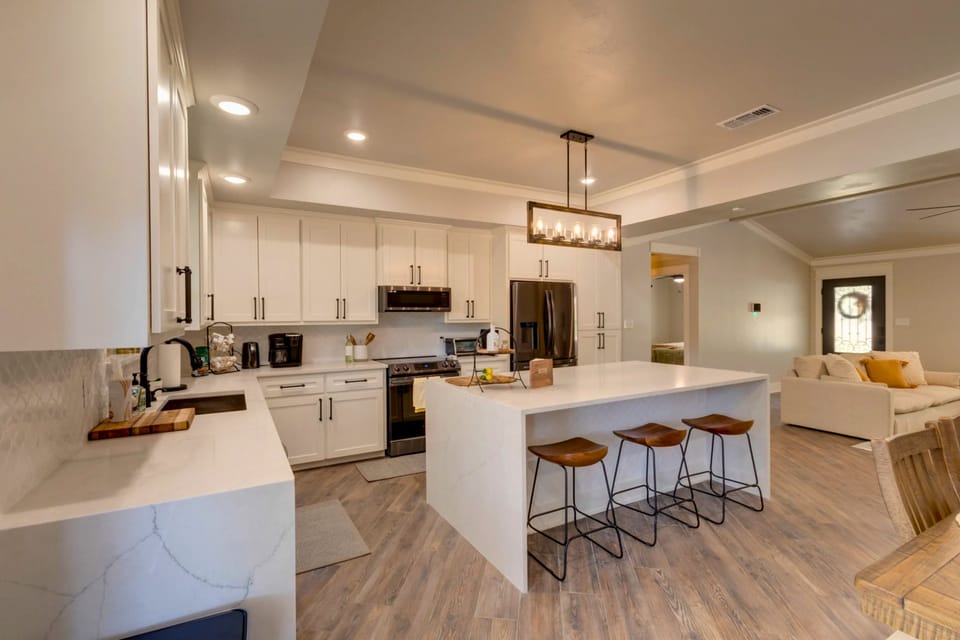 Bright kitchen with large island seating and modern stainless appliances