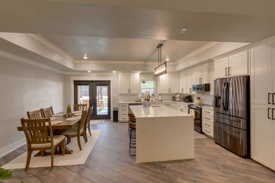 Open kitchen and dining area with large island and backyard access