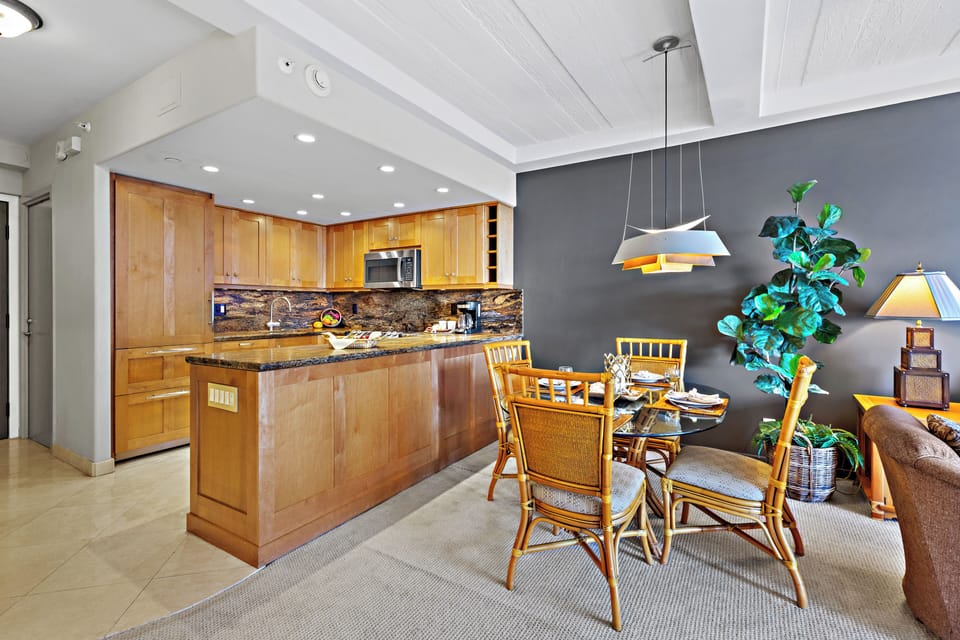 Enjoy the convenience of a fully equipped kitchen and open dining area, perfect for preparing meals, gathering with family and friends, and creating memorable moments during your Maui getaway.