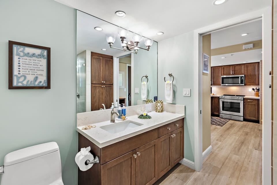 This stylish guest bathroom offers a spacious vanity, contemporary lighting, and elegant finishes, creating a welcoming space for guests to prepare for another day in paradise