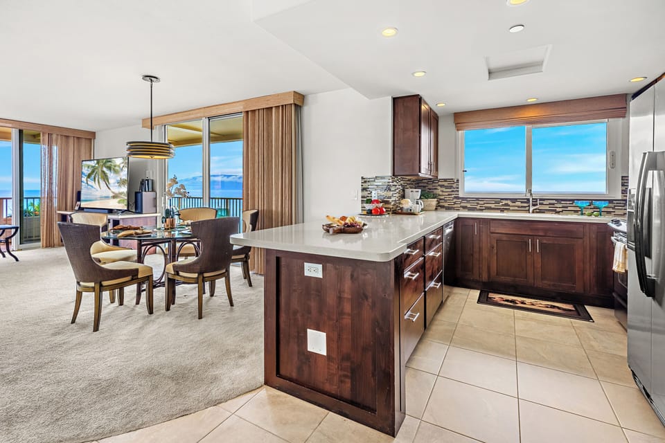 The beautifully updated kitchen and dining area provide the perfect setting for gathering with family and friends while taking in panoramic ocean views.
