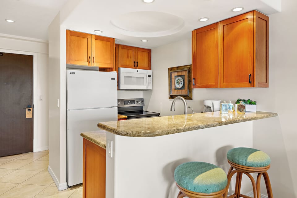 Fully equipped kitchen with a generous breakfast bar, comfortable seating, and modern appliances. Ideal for casual dining or enjoying your morning coffee before a day in paradise.