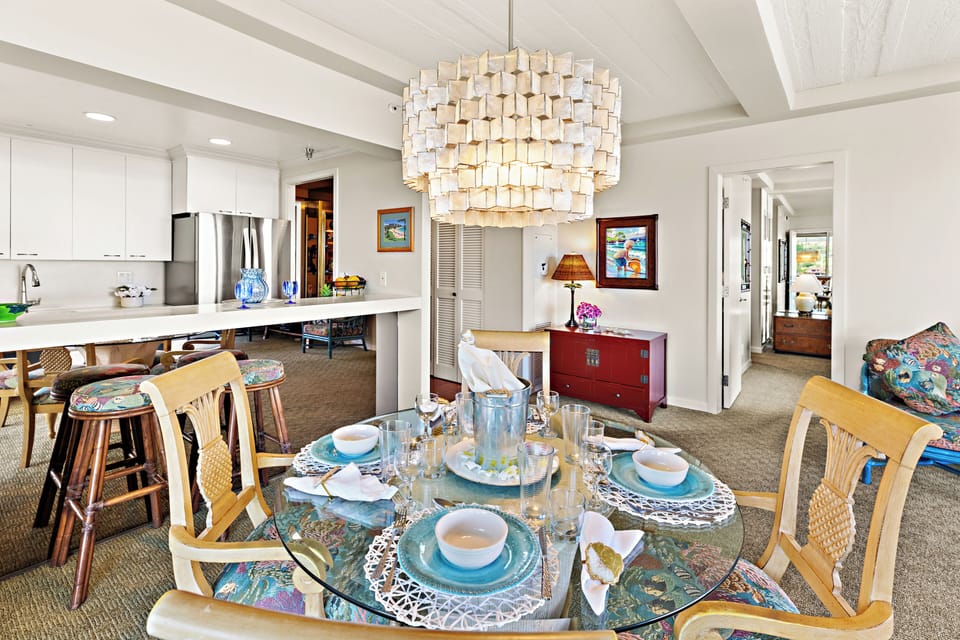 Share meals and unwind in this cozy dining space, perfect for morning coffee and laid-back island moments.