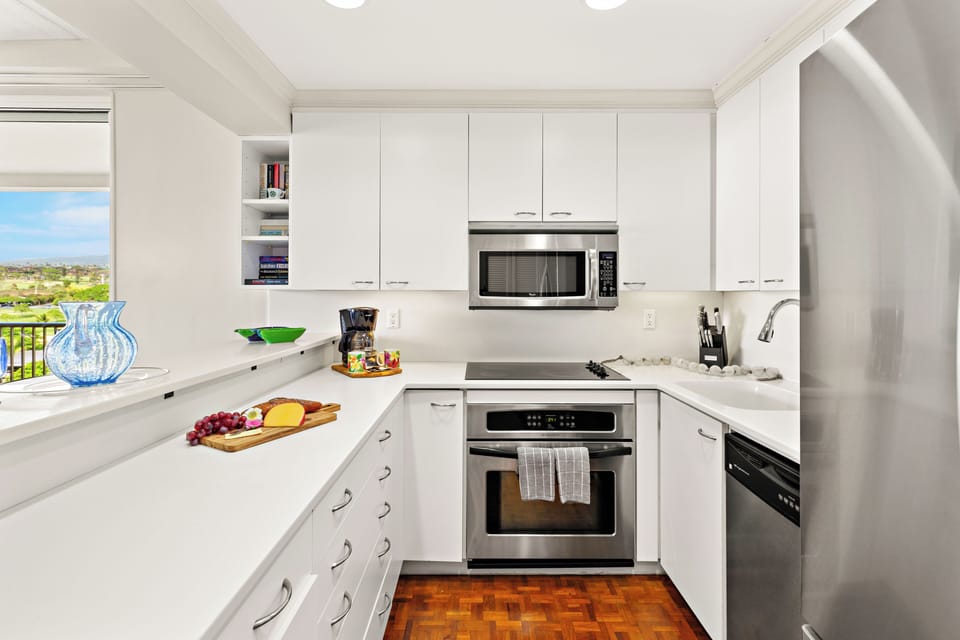Thoughtfully designed for relaxed resort living, this bright and modern kitchen features sleek quartz countertops, stainless steel appliances, and a clean coastal aesthetic—perfect for preparing your favorite island inspired meals.