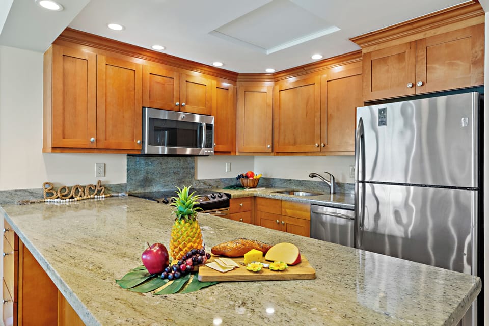 Your gourmet kitchen awaits with rich wood cabinetry, granite counters, and stainless-steel appliances. Perfect for preparing memorable meals together.